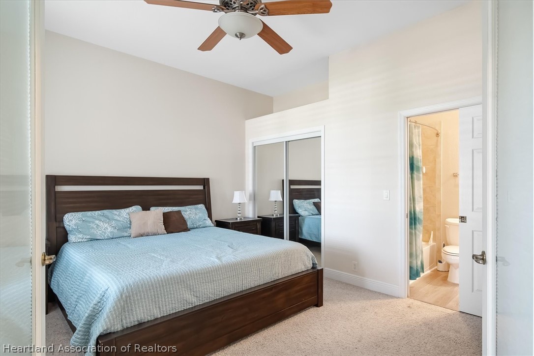 5224 Haw Branch Road Sebring, FL 33875 - Photo 25 of 40 a bedroom with a bed and a chandelier