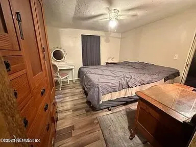 a bedroom with a bed and mirror