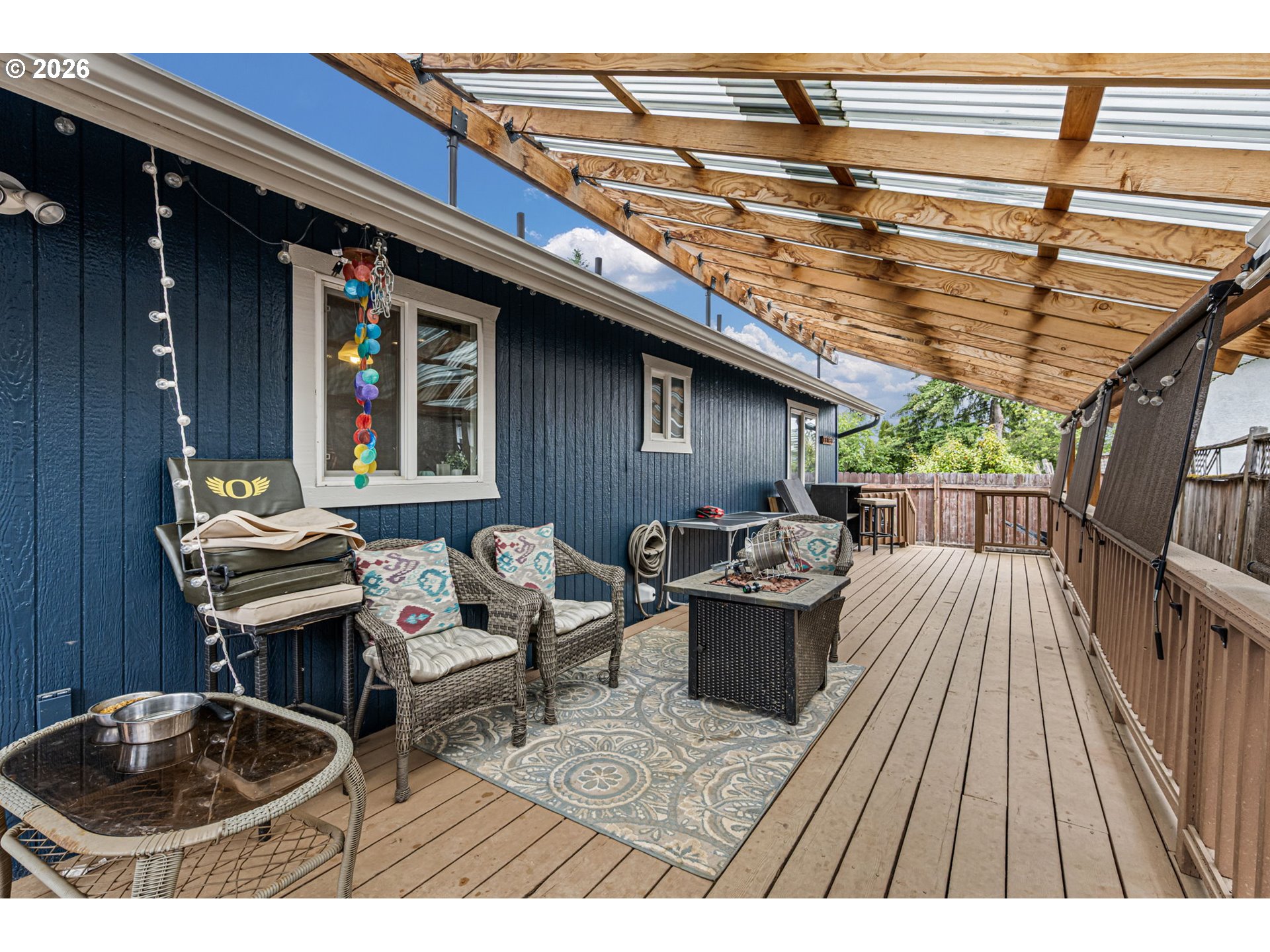 1055 Ash Grove Loop Creswell, OR 97426 - Photo 26 of 33 a backyard of a house with barbeque oven table and chairs