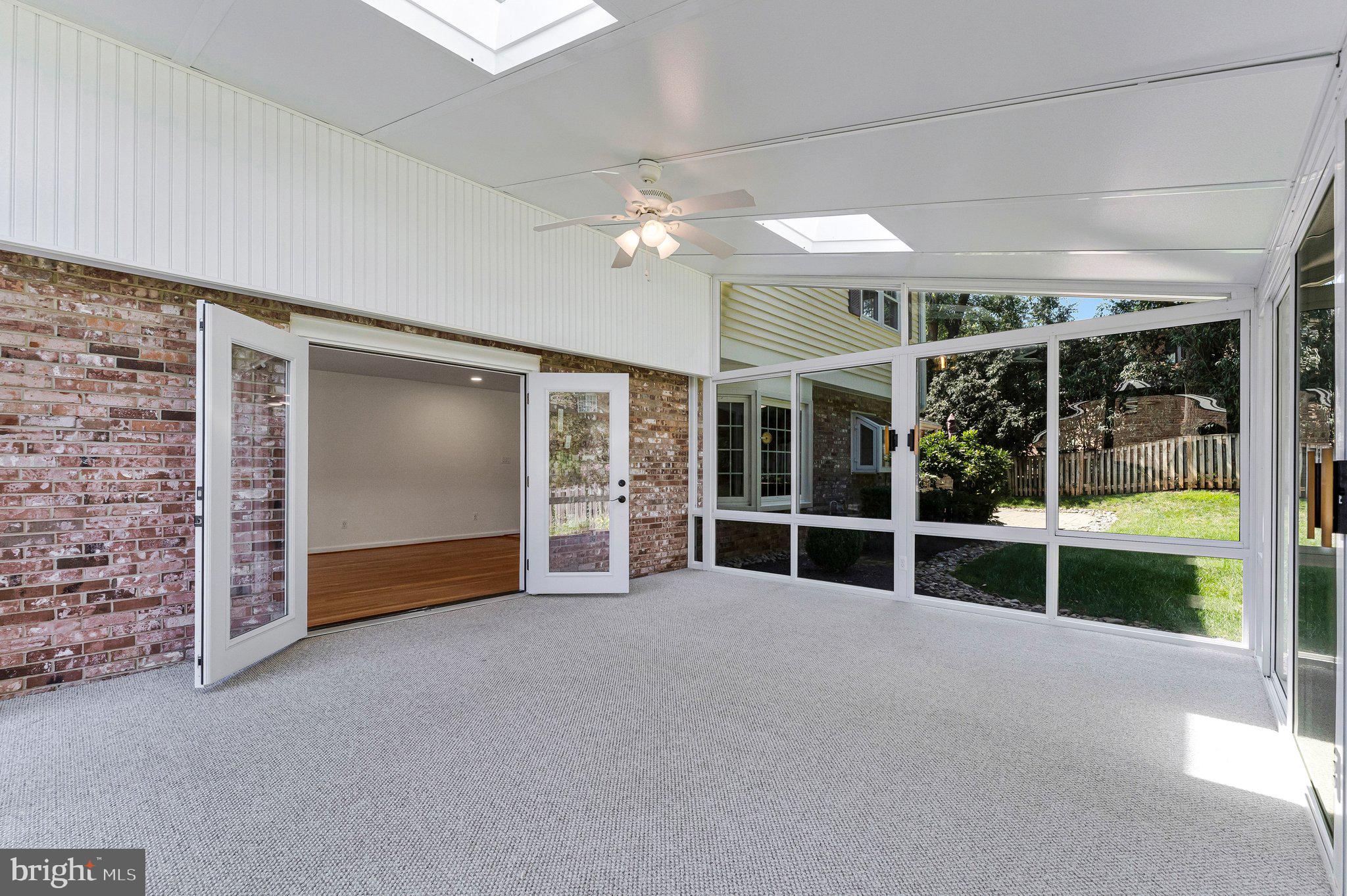 7730 Falstaff Road McLean, VA 22102 - Photo 69 of 83 Large sunroom with ceiling fan and skylights