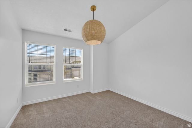 14771 Haddington Road Draper, UT 84020 - Photo 25 of 44 Room featuring two white-framed windows with blinds, a woven pendant light fixture, light gray carpet, and white baseboards