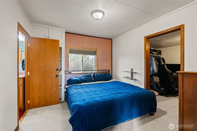 a bed room with a bed and a television