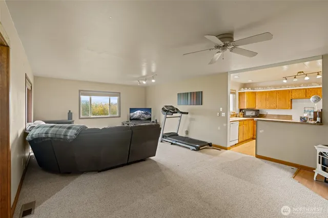 a living room with furniture and a wooden floor