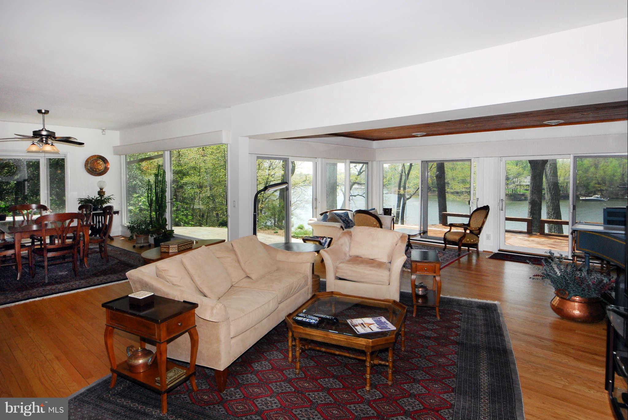 892 Childs Point Road Annapolis, MD 21401 - Photo 8 of 28 Living room with wall of windows sweeping views