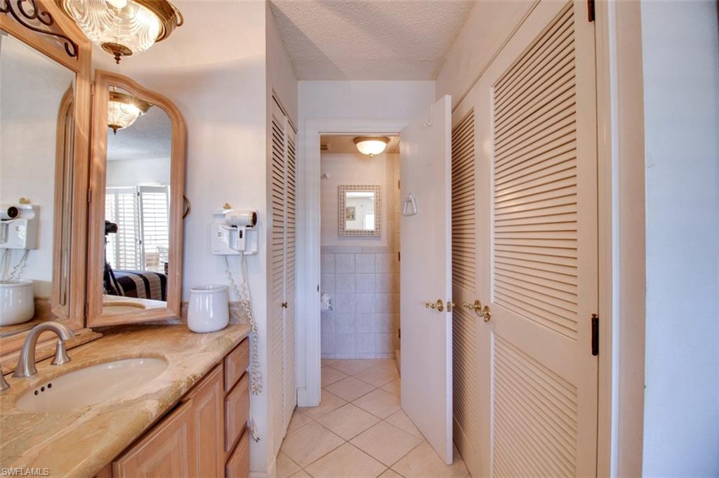 250 7th Avenue South, Unit 305 Naples, FL 34102 - Photo 12 of 24 a bathroom with a sink and a mirror