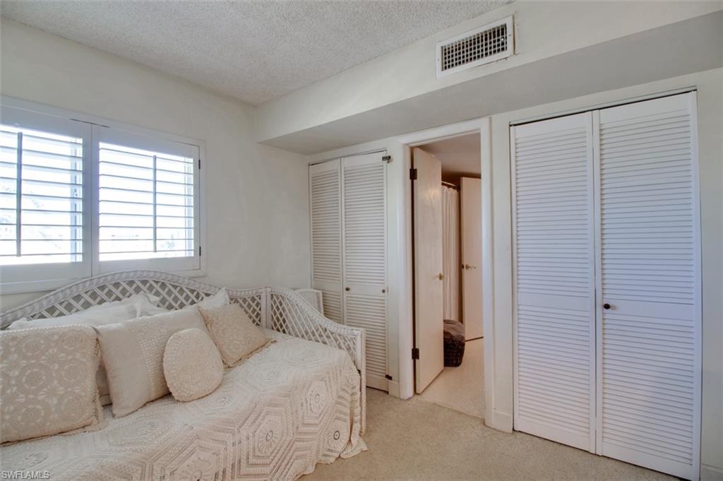 250 7th Avenue South, Unit 305 Naples, FL 34102 - Photo 14 of 24 a spacious bedroom with a bed and a window