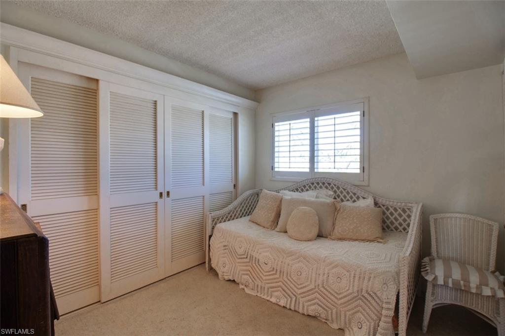250 7th Avenue South, Unit 305 Naples, FL 34102 - Photo 15 of 24 a bedroom with a bed and a window