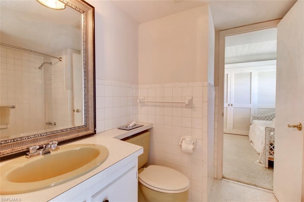 250 7th Avenue South, Unit 305 Naples, FL 34102 - Photo 17 of 24 a bathroom with a sink a toilet and shower