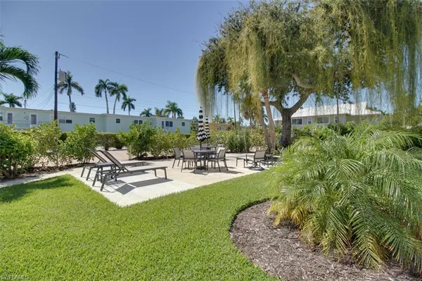 a swimming pool with outdoor seating and yard