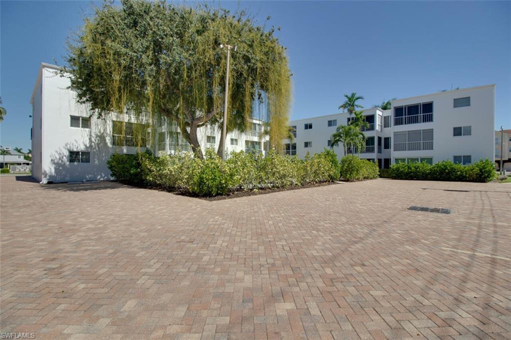 250 7th Avenue South, Unit 305 Naples, FL 34102 - Photo 20 of 24 a view of a house with a street