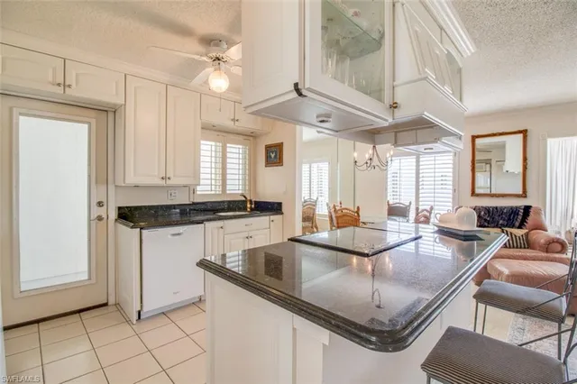 a kitchen with center island table and chairs