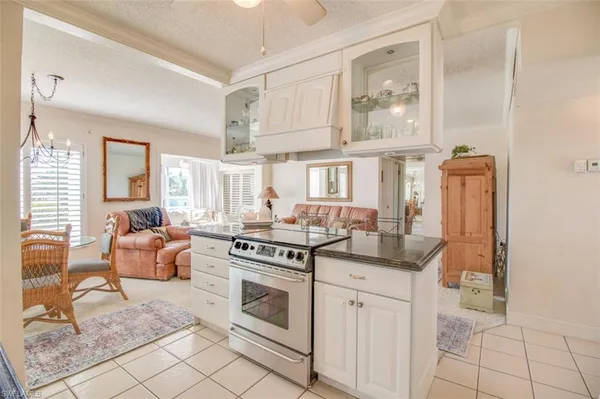 a kitchen with stainless steel appliances granite countertop a stove and white cabinets