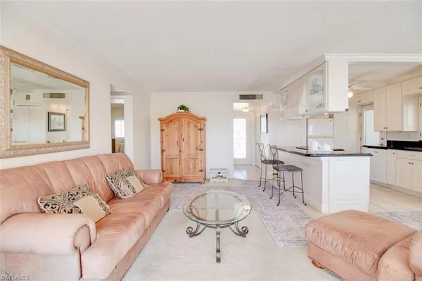 a living room with furniture and kitchen view