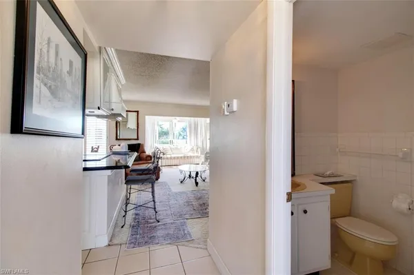 a view of bathroom with a toilet sink and mirror