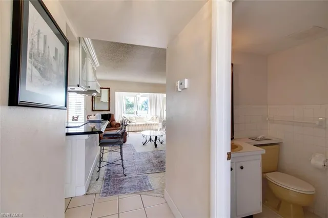 a view of bathroom with a toilet sink and mirror