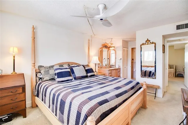 a bedroom with bed and a chandelier