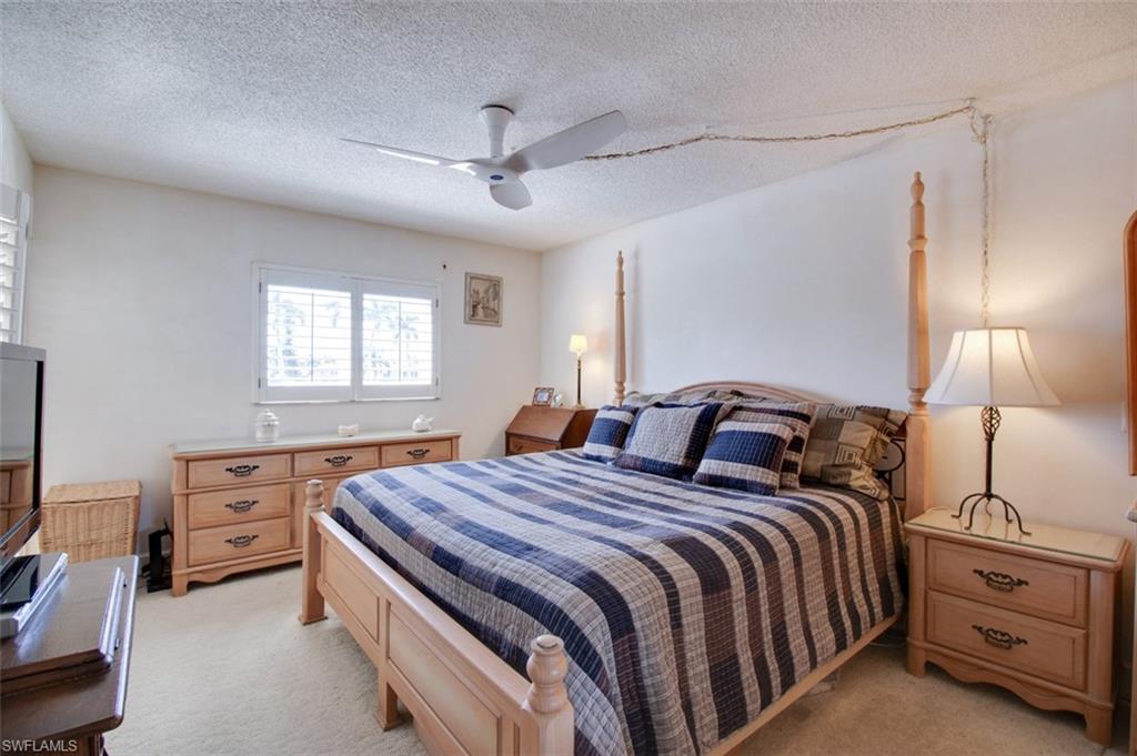 250 7th Avenue South, Unit 305 Naples, FL 34102 - Photo 10 of 24 a bedroom with a bed and a window