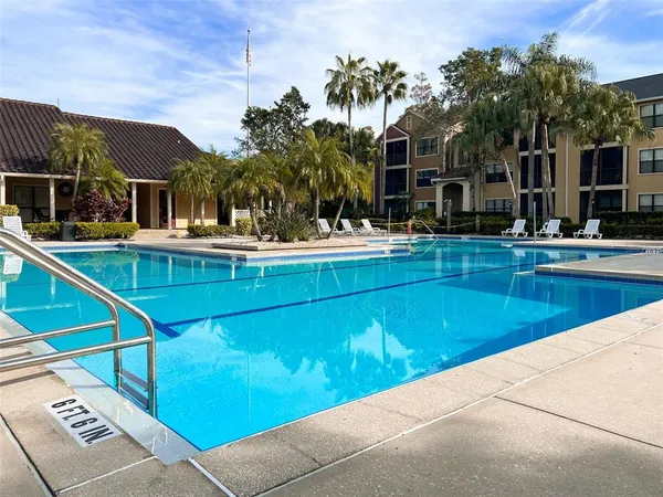 a view of house with swimming pool outdoor seating