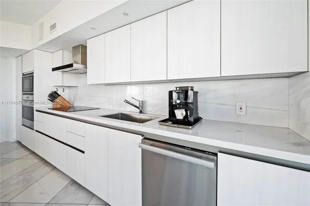 a kitchen with a sink and cabinets