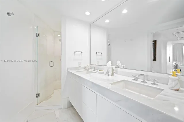 a bathroom with double sink and a mirror