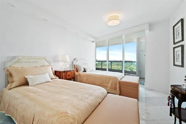 a bedroom with a large bed and a large window