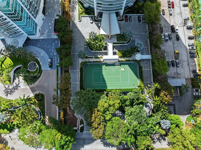 a living room with furniture kitchen view and a large window