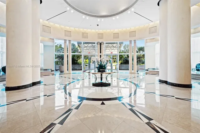 a dining room with wooden floor and a floor to ceiling window