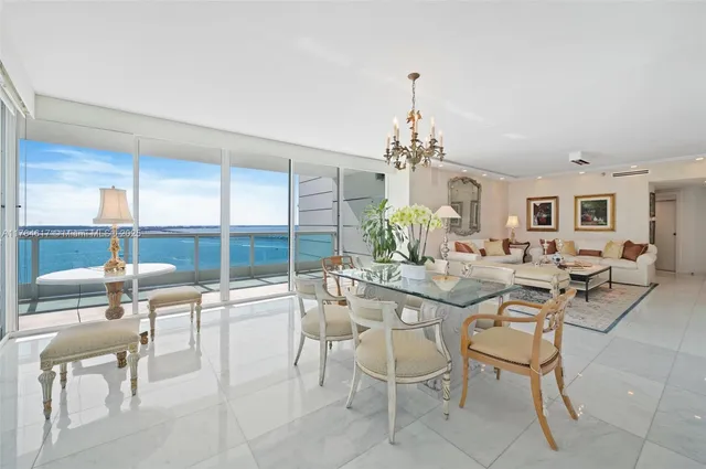 a dining room with furniture a chandelier and a rug