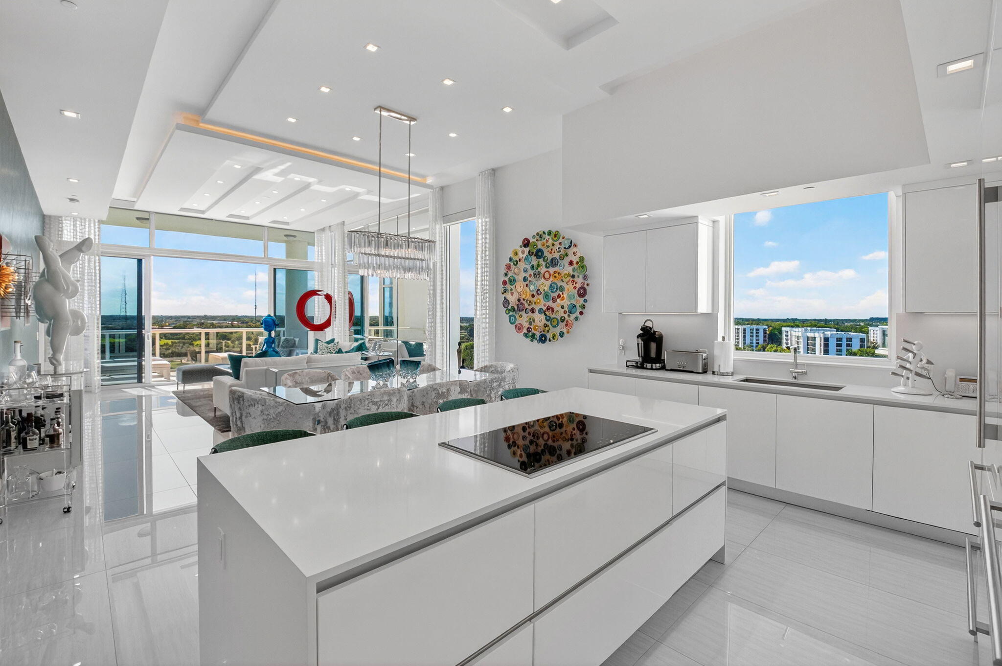 20155 Boca W Drive, Unit PHB904 Boca Raton, FL 33434 - Photo 12 of 50 a kitchen that has a lot of cabinets in it and wooden floors