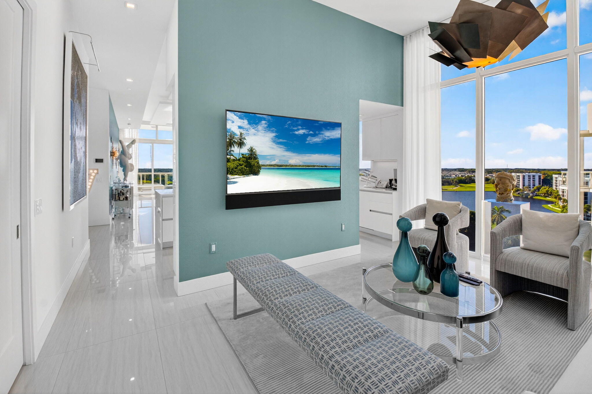 20155 Boca W Drive, Unit PHB904 Boca Raton, FL 33434 - Photo 27 of 50 a living room with furniture a chandelier and a painting on the wall