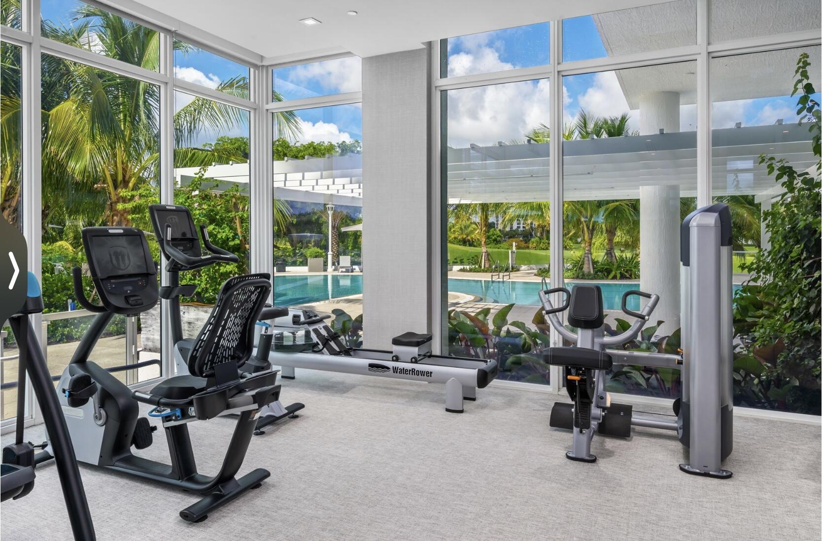 20155 Boca W Drive, Unit PHB904 Boca Raton, FL 33434 - Photo 34 of 50 a room with gym equipment and a large window