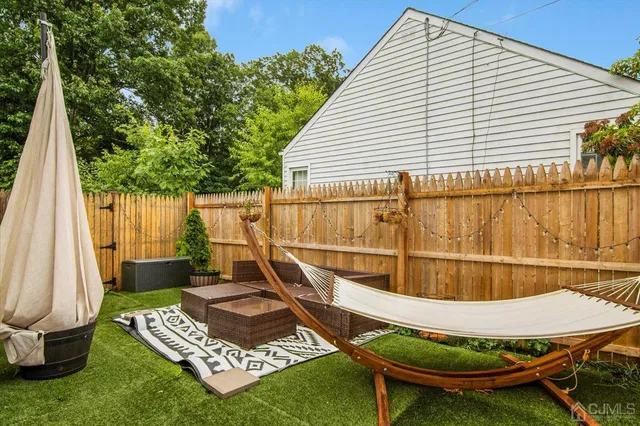 a view of a backyard with table and chairs