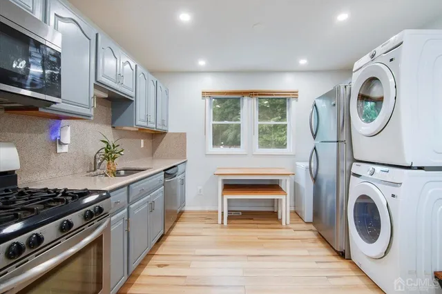 a kitchen with stainless steel appliances granite countertop a stove and a sink