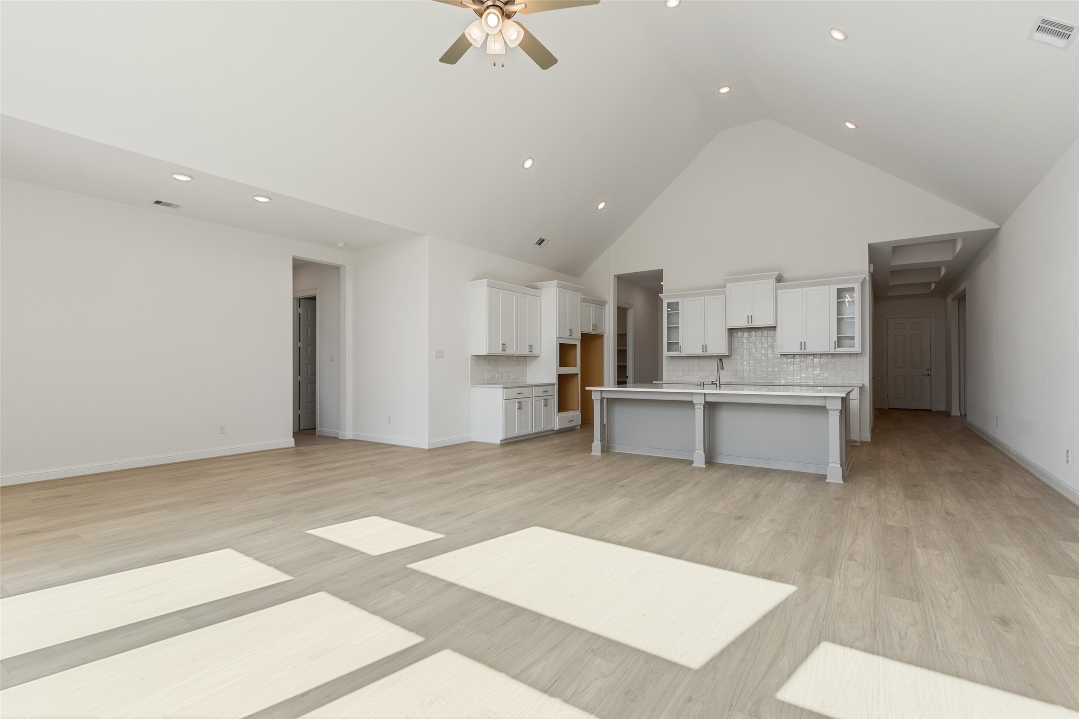 338 Blue River Trail Rosenberg, TX 77471 - Photo 13 of 36 a large white kitchen with kitchen island a sink stainless steel appliances and cabinets