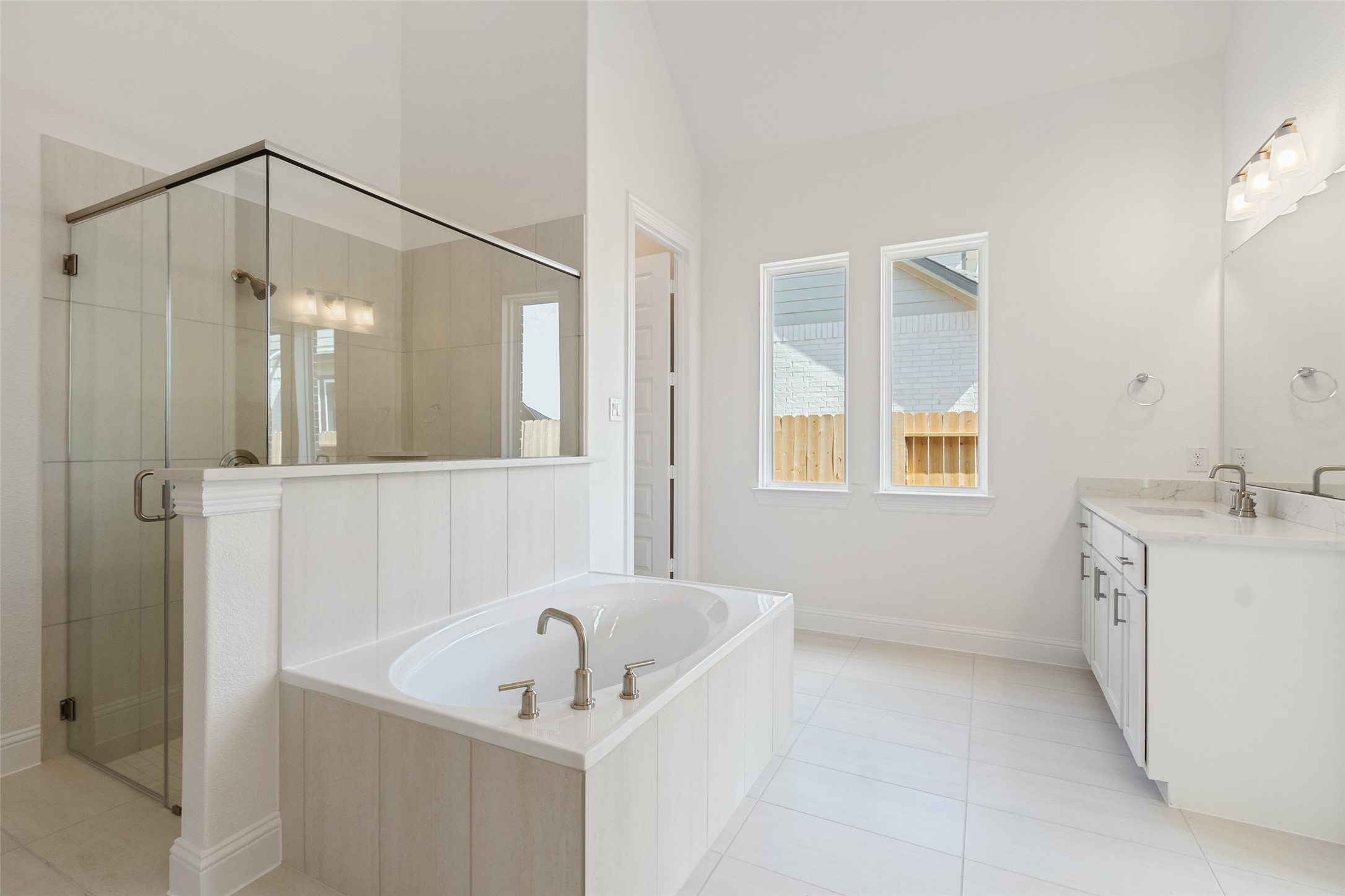 338 Blue River Trail Rosenberg, TX 77471 - Photo 19 of 36 a bathroom with a sink a tub and a mirror