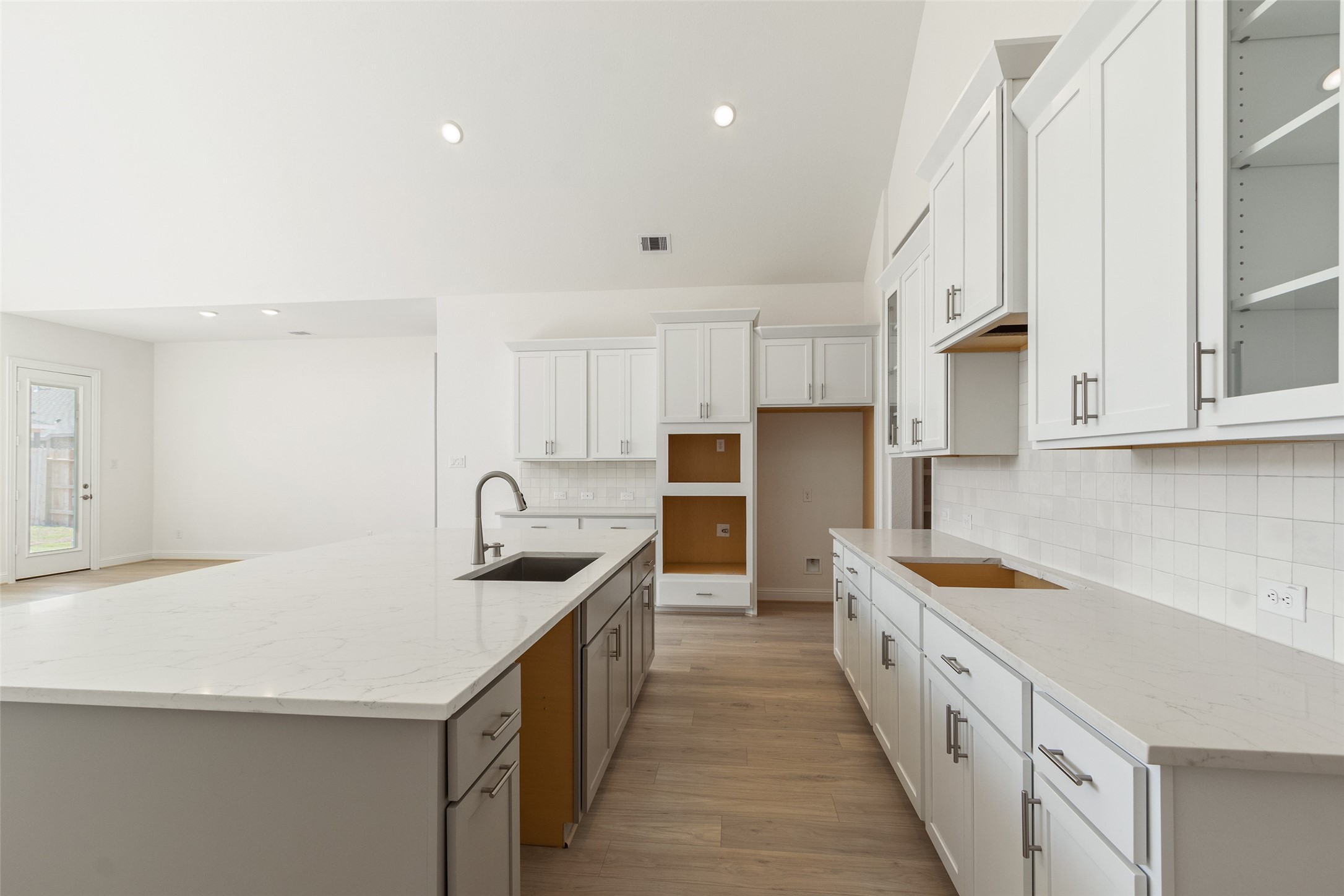 338 Blue River Trail Rosenberg, TX 77471 - Photo 8 of 36 a kitchen with granite countertop a sink stove and cabinets