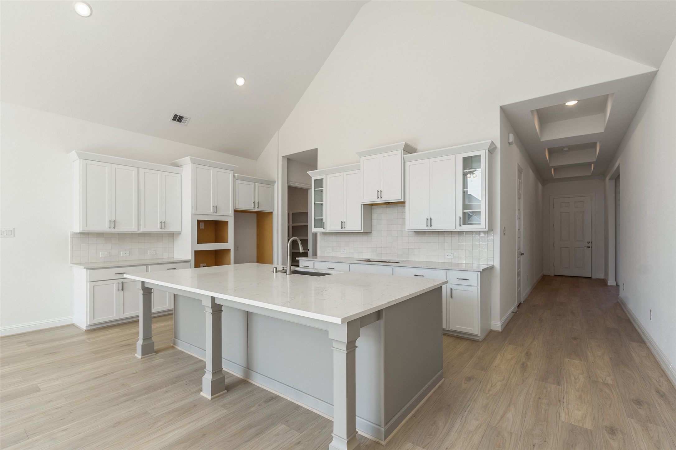 338 Blue River Trail Rosenberg, TX 77471 - Photo 9 of 36 a kitchen with a sink a stove a refrigerator and white cabinets
