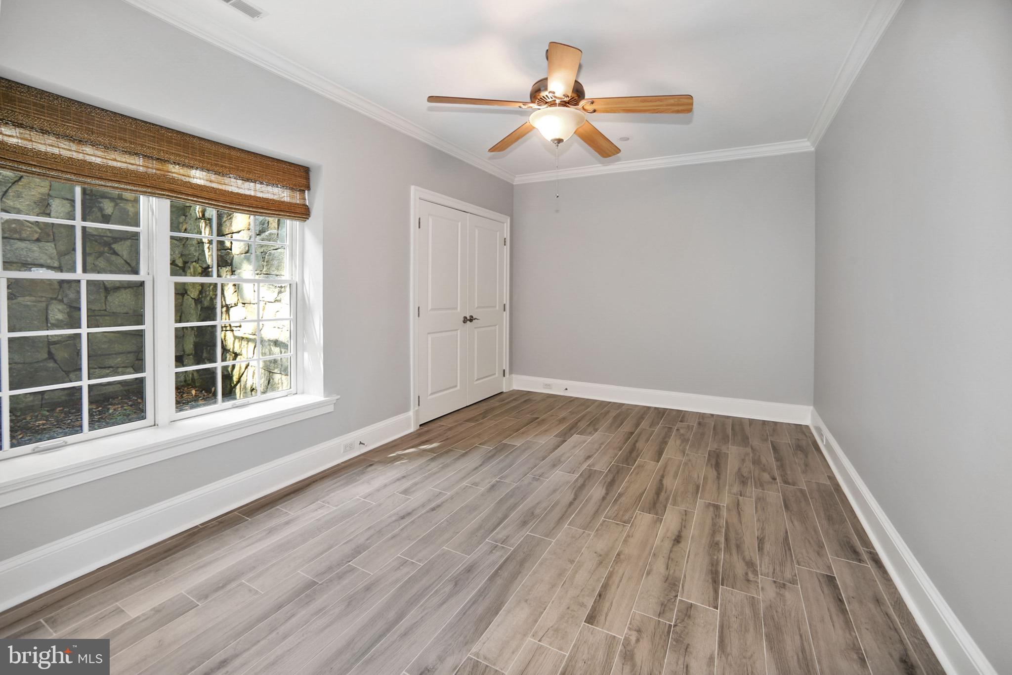 7117 Exfair Road Bethesda, MD 20814 - Photo 39 of 42 wooden floor in an empty room with a window