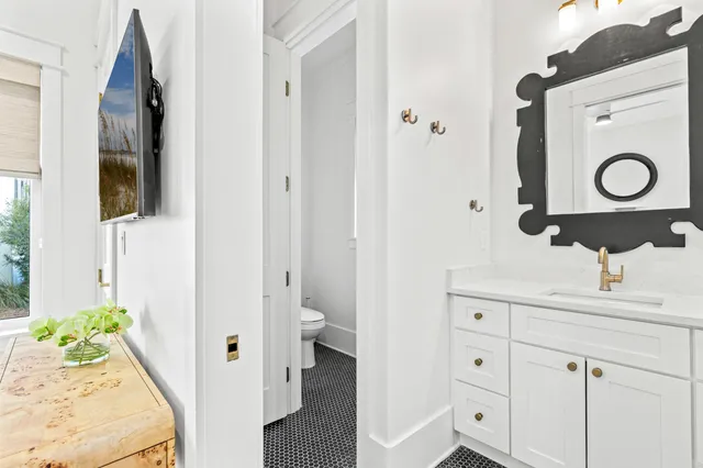 a bathroom with a toilet and a shower curtain