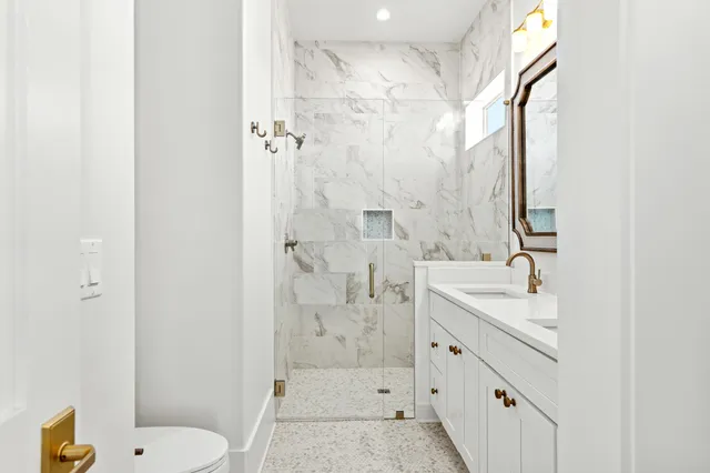 a view of a terrace with a lawn chairs under an umbrella