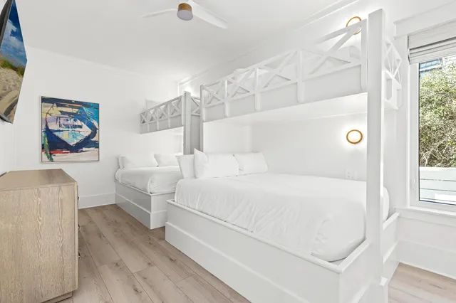 a bedroom with a bed and a large window with outer view