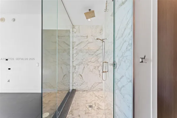 a white toilet sitting next to a white wall