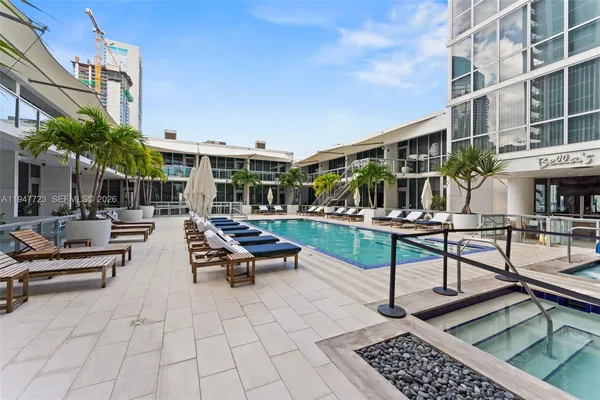 a view of a swimming pool with chairs in patio