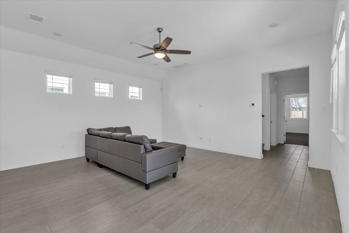 12620 Penguin Path Manor Manor, TX 78653 - Photo 14 of 37 Living area featuring a ceiling fan and light wood finished floors