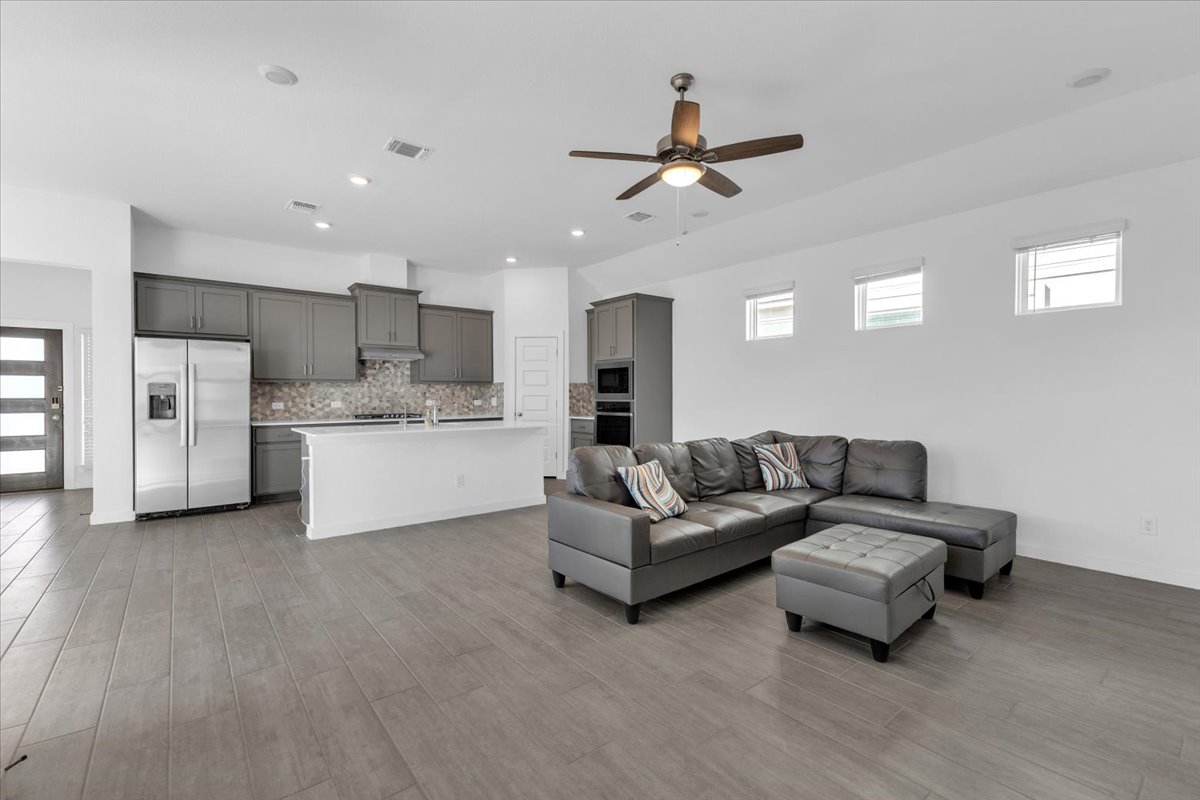 12620 Penguin Path Manor Manor, TX 78653 - Photo 15 of 37 Living area featuring a ceiling fan, light wood-style flooring, and recessed lighting