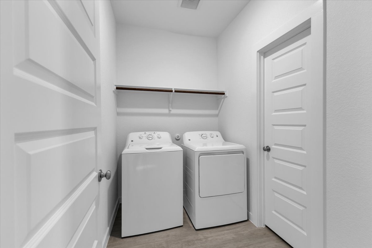 12620 Penguin Path Manor Manor, TX 78653 - Photo 18 of 37 Laundry area with light wood-type flooring and separate washer and dryer