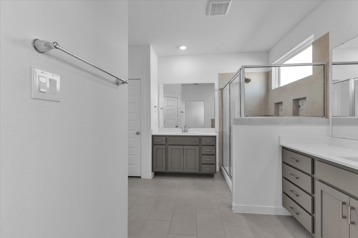 12620 Penguin Path Manor Manor, TX 78653 - Photo 20 of 37 Bathroom with a shower stall and two vanities