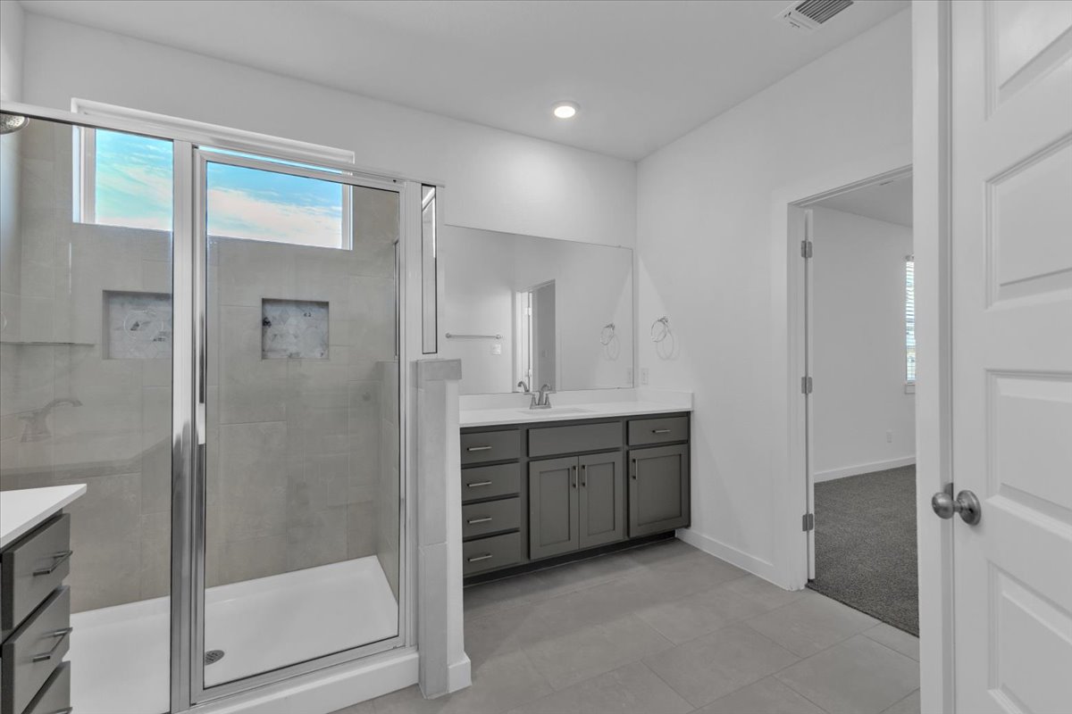 12620 Penguin Path Manor Manor, TX 78653 - Photo 21 of 37 Bathroom featuring vanity, a stall shower, light tile patterned floors, and recessed lighting