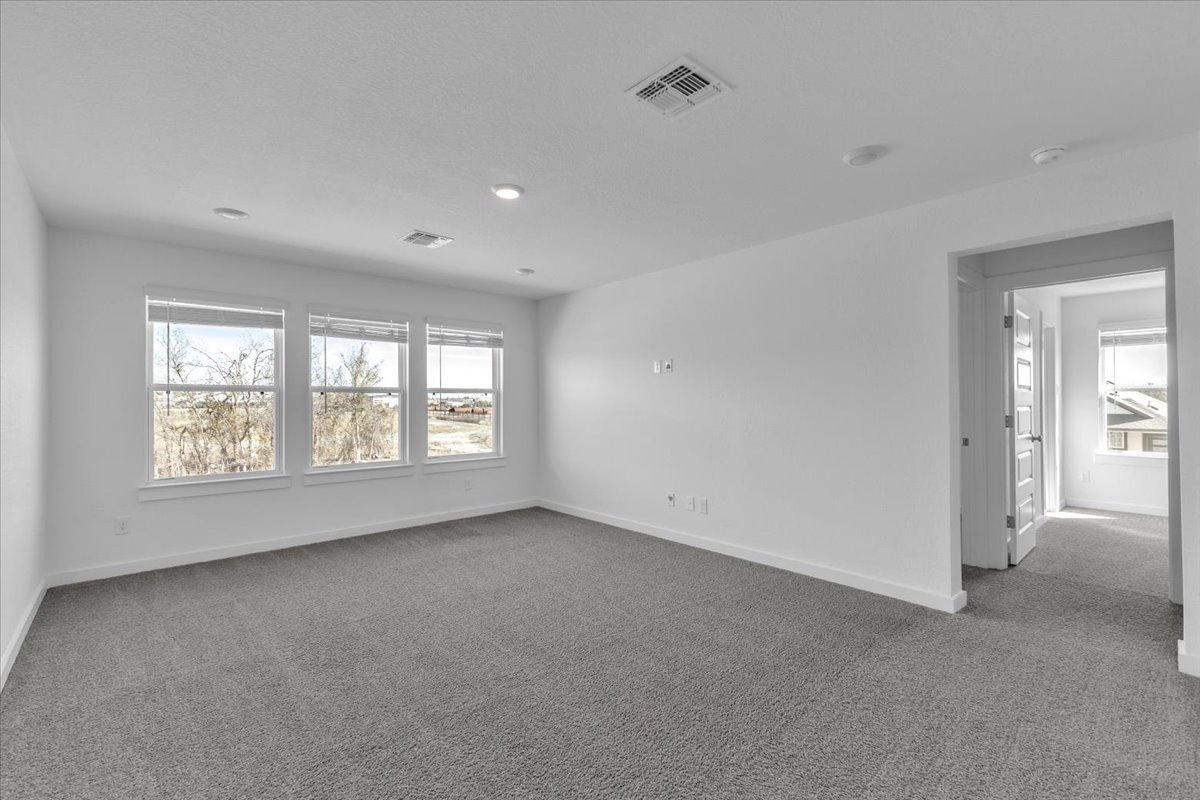 12620 Penguin Path Manor Manor, TX 78653 - Photo 24 of 37 Empty room with light colored carpet