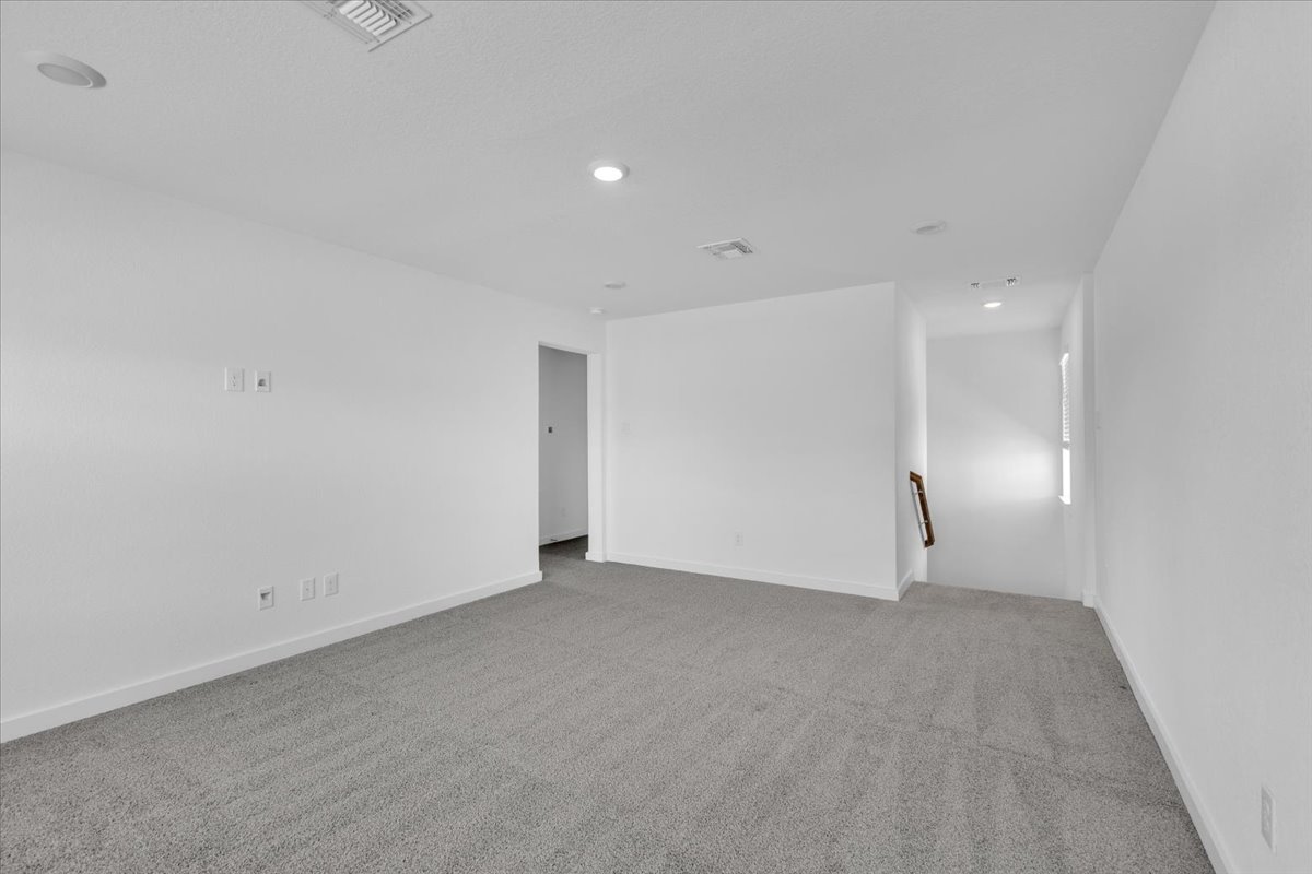 12620 Penguin Path Manor Manor, TX 78653 - Photo 25 of 37 Spare room featuring light colored carpet and recessed lighting